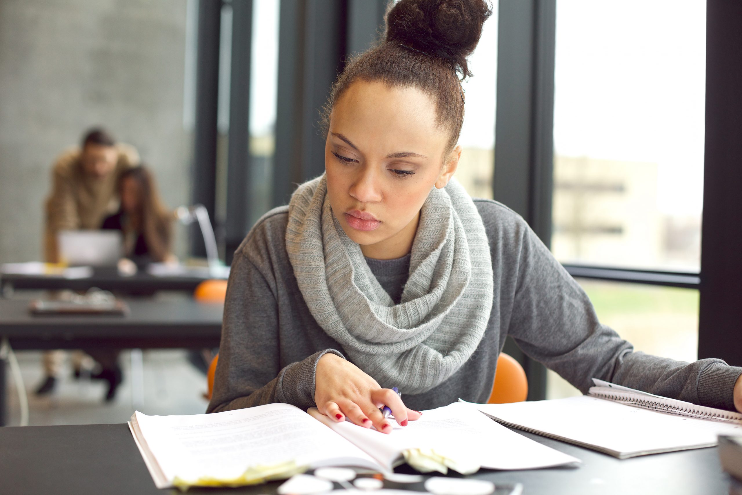 woman working on paper at desk