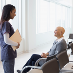 bald woman receiving medical results from female nurse