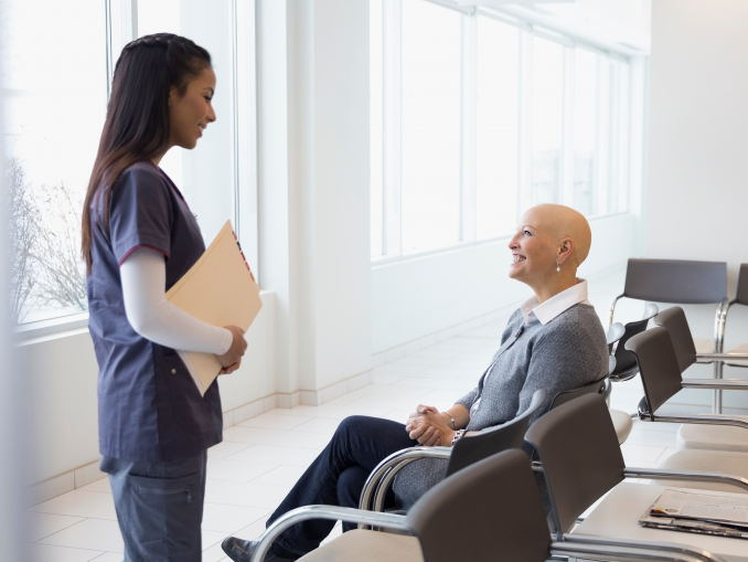 bald woman receiving medical results from female nurse