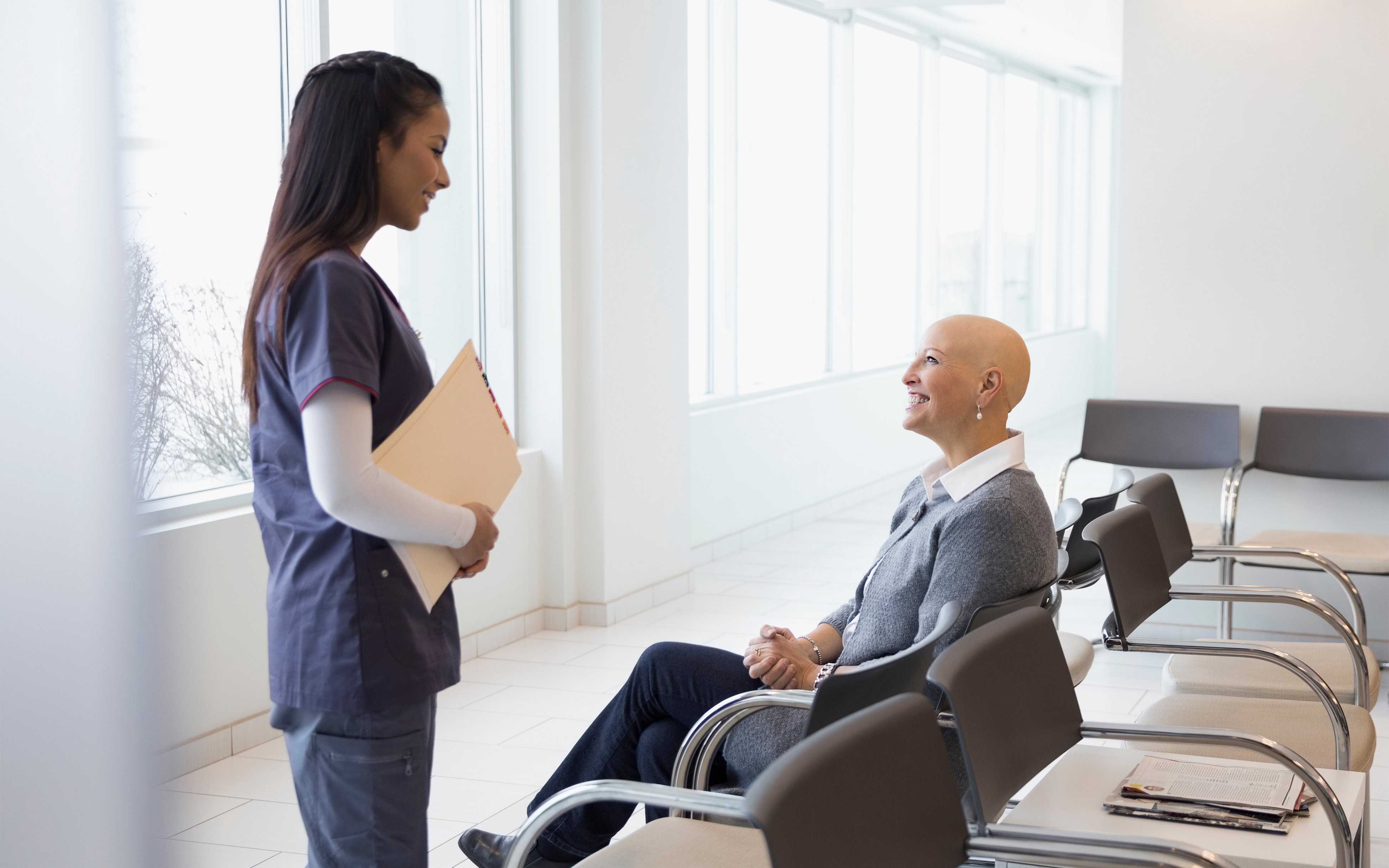 bald woman receiving medical results from female nurse