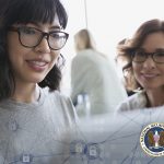 two women looking at a laptop