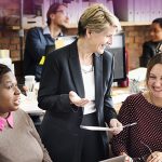 three professional women laughing