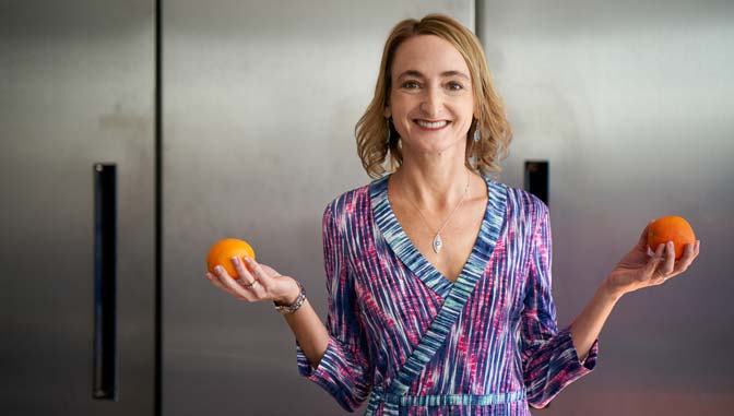 Carmen Roberts, dietician, standing in a kitchen