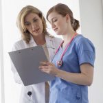 nurse and manager conferring over chart