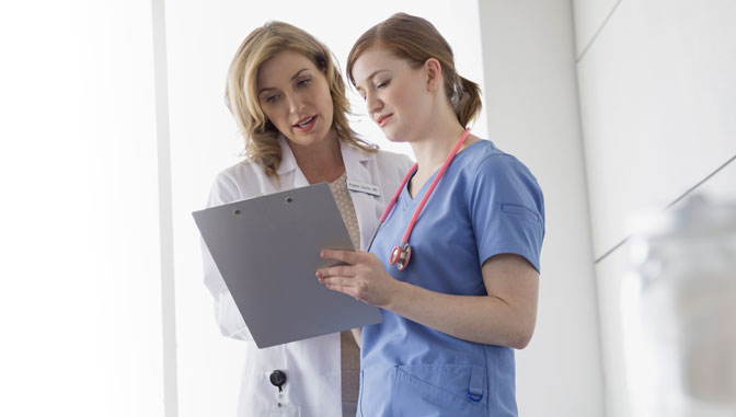 nurse and manager conferring over chart