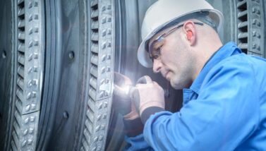 Technician inspecting machinery