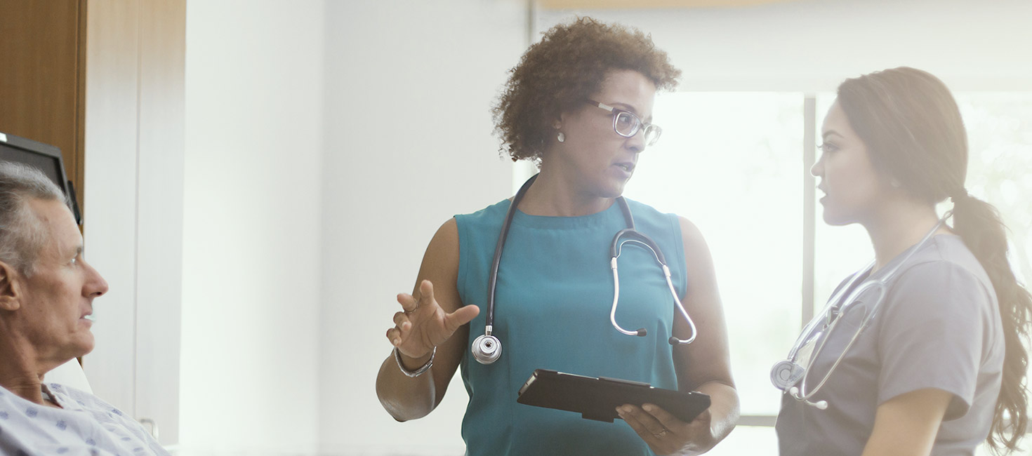 Nurses consulting with each other in a teaching facility