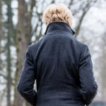 Woman with back turned in winter, suffering from Seasonal Affective Disorder