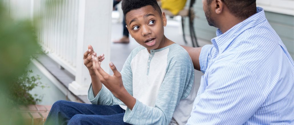 african american dad talking to son instead of putting him in time out