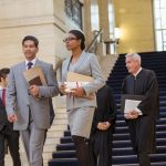 lawyers walking through a court house and the start of the criminal justice system