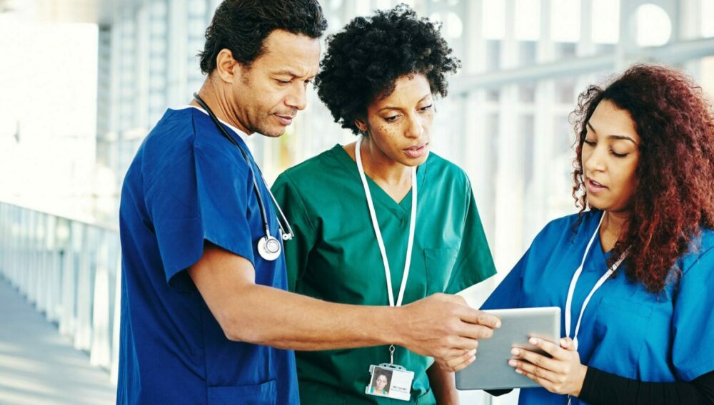 diverse group of nurses looking at a patient chart.