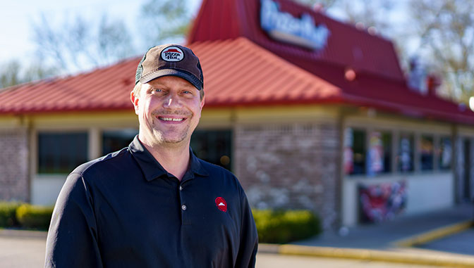 Ron Kiernicki, Excelsior Student in front of the Pizza Hut he works for