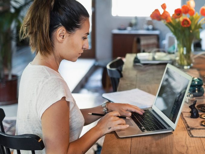 woman at computer, going back to school with GI Bill Benefits