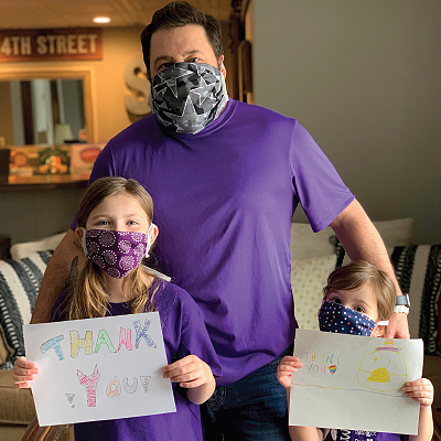 Excelsior employee family with thank you signs