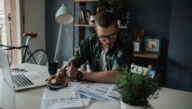 A student balancing his finances examines his tuition costs. Deferment and forbearance are two options for students experiencing financial difficulties.