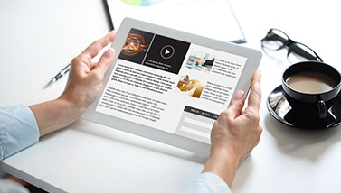 Person holding tablet and reading articles