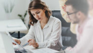 A nonprofit administrator and her colleague review the budget for a new public assistance program.