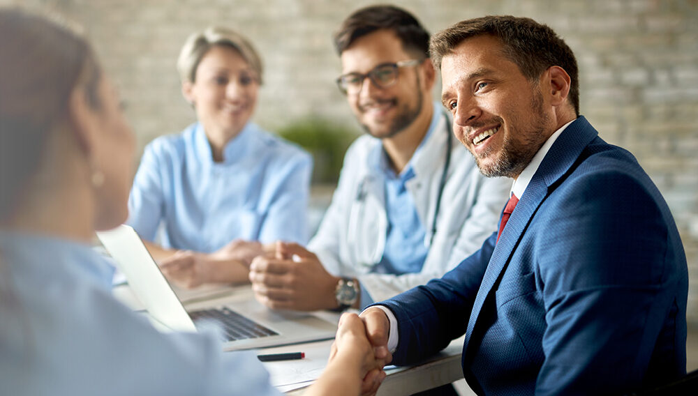 A hospital administrator congratulates his team for a job well done