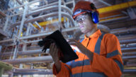 A nuclear engineer adjusts a thermal control panel in a nuclear power plant.