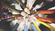 Center for Social Justice image features the hands of many people joined in a circle