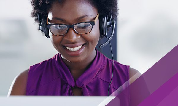 Woman wearing headset in front of laptop