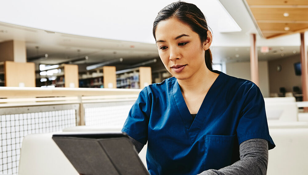 a nursing student studies on a laptop