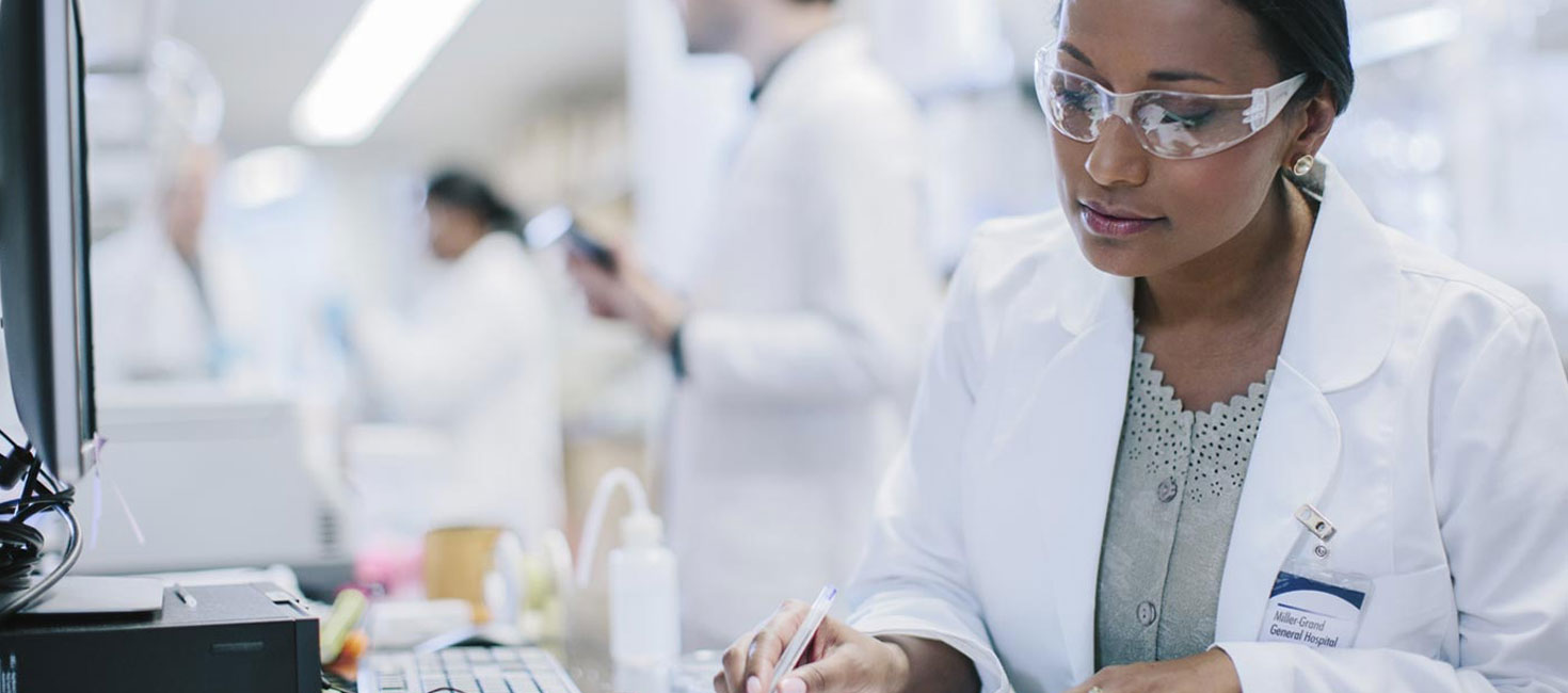 MS in Health Sciences graduate reviewing laboratory regulations document