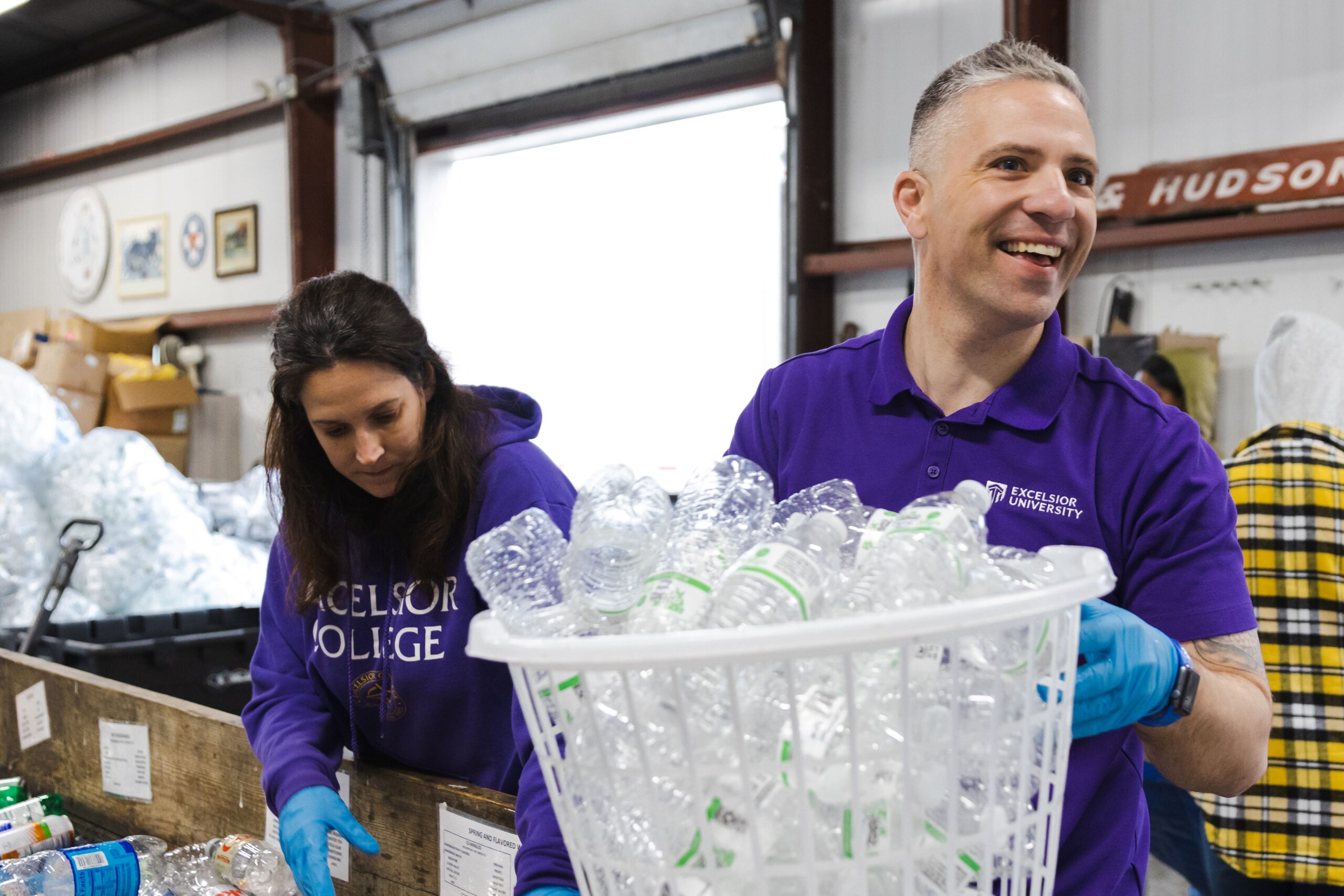 Excelsior University volunteers gather on a dock during a Humane Society outreach event.
