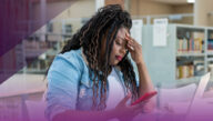 stressed out female college student in school library