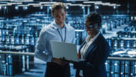 IT man and woman working on laptop