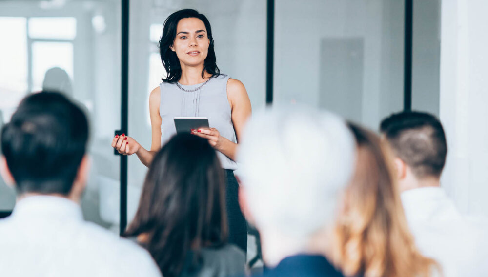 female business leader speaking to co-workers