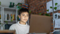 female adult student studying on laptop