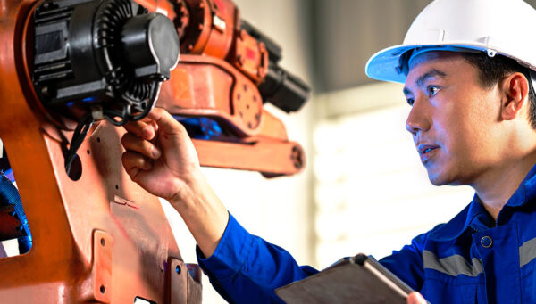 Mechanical engineering technician inspects a large motor