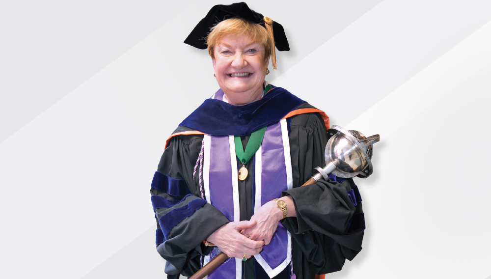 Mary Beth Hanner holding academic mace