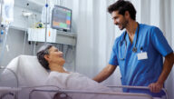 Nurse checking on patient in the intensive care unit