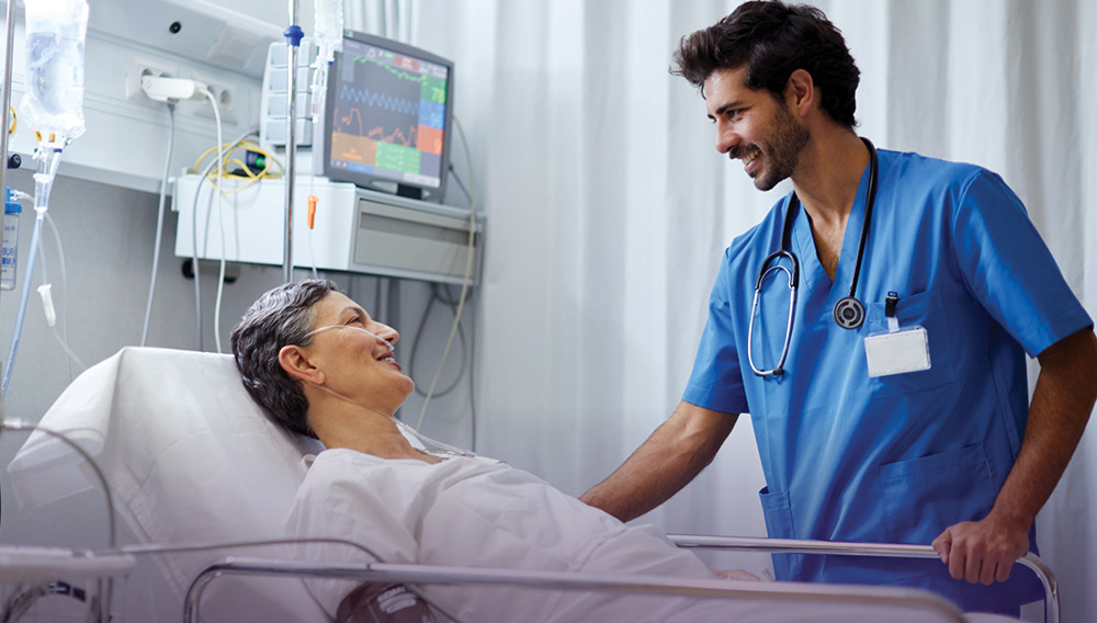 Nurse checking on patient in the intensive care unit