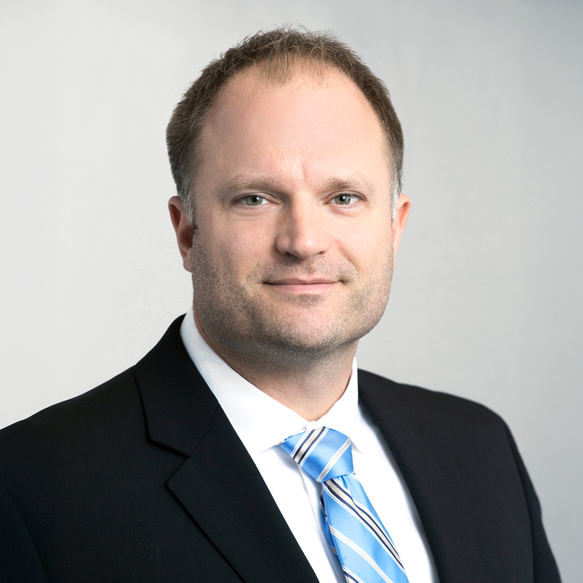 professional headshot of man in suit