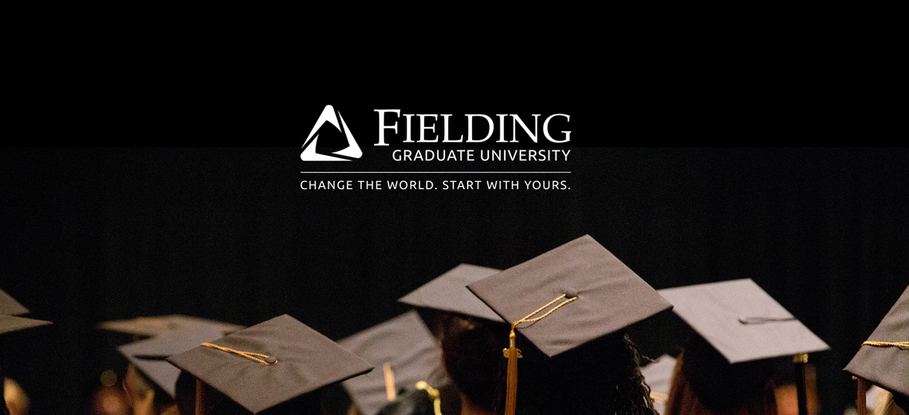 view of graduates from behind, looking forward during graduation