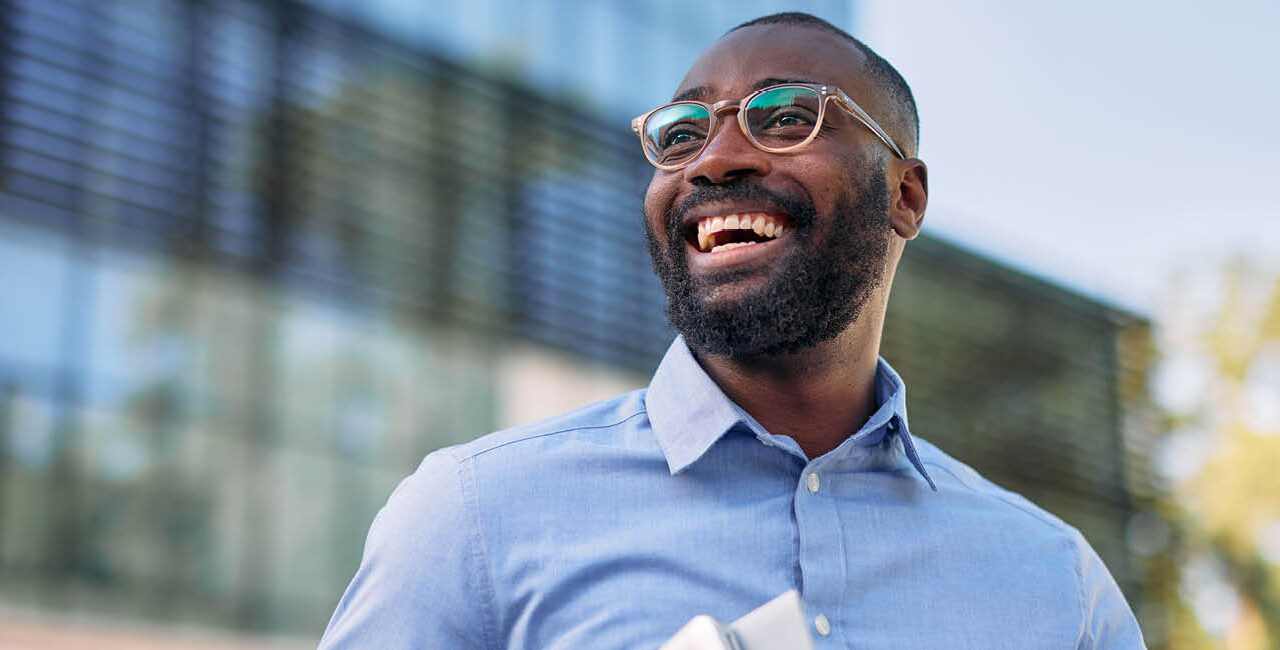 smiling man outside an office building