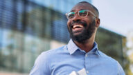 smiling man outside an office building