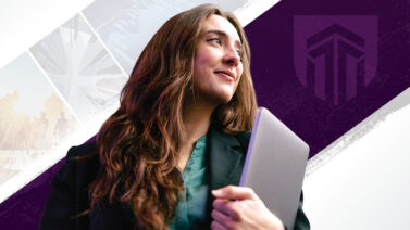 Woman holding laptop and looking into the distance