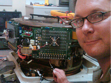 Jesse Bradley repairing an electronic device.