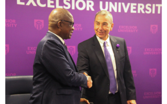 Presidents of Excelsior University and UVCI shake hands