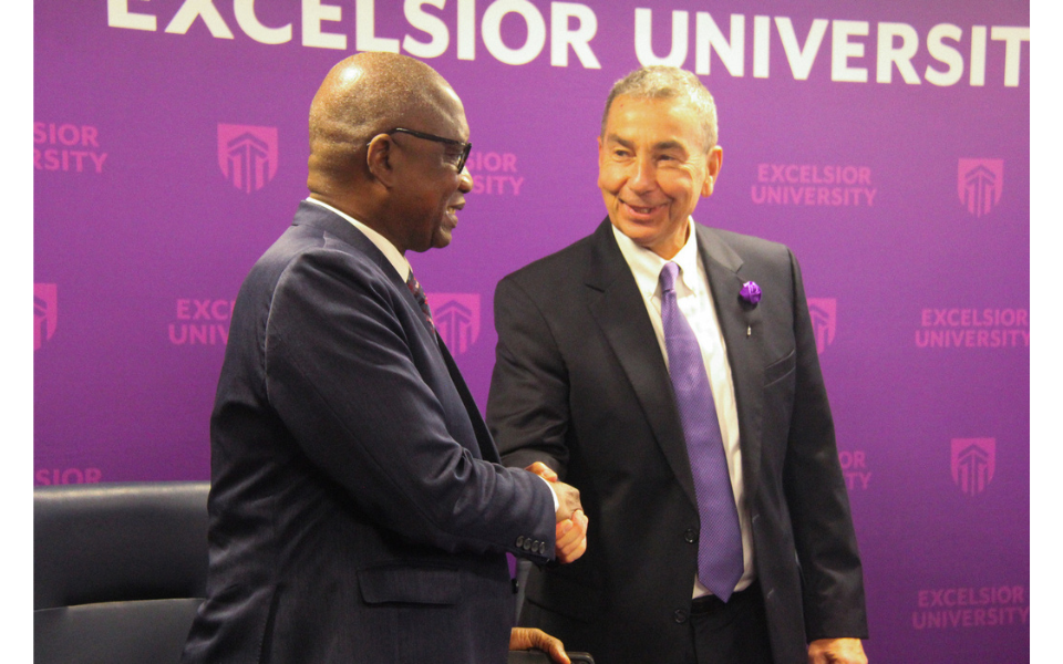 Presidents of Excelsior University and UVCI shake hands