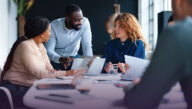 Co-workers collaborating on a project at a table