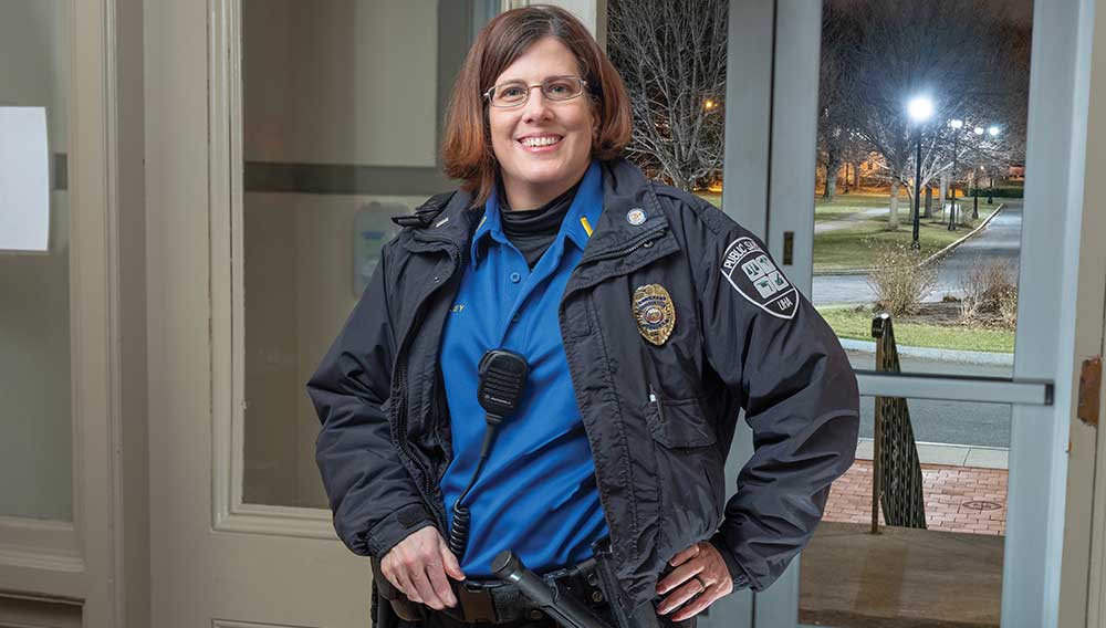 A smiling, female officer is ready to serve
